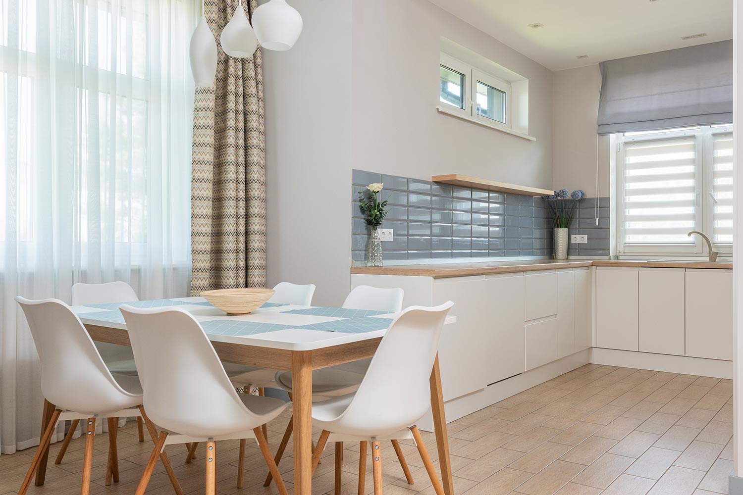 kitchen with tall ceilings and a table with chairs