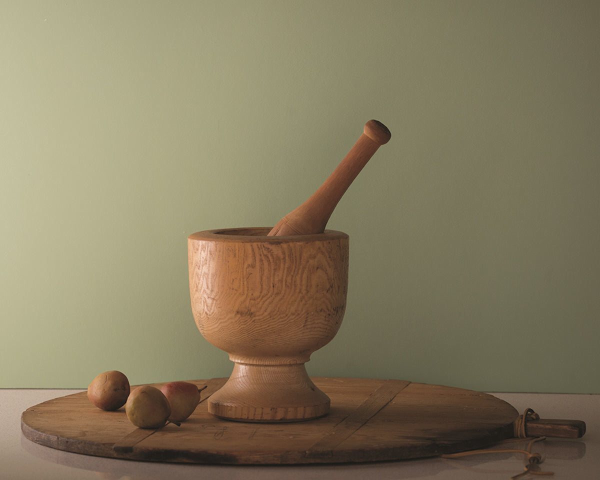 Fernwood green wall with wood mortar and pestle set on a lazy susan.